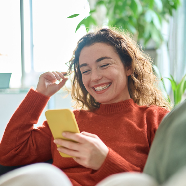 Woman wearing contact lenses while using her phone.