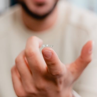A contact lens resting on a finger.