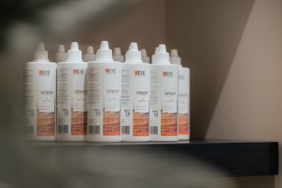 Many Extrasept contact lens solutions standing side by side.