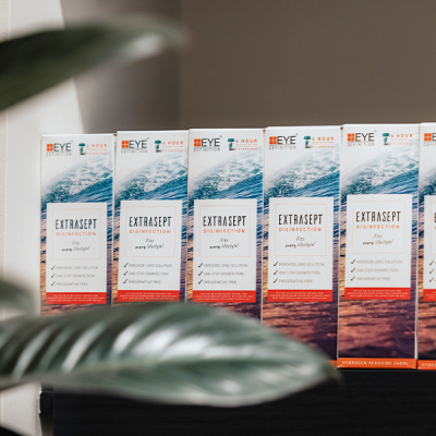 Many Extrasept contact lens solutions standing side by side.